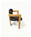 Prevelly PU Dining Chair in black PU with a timber frame, side view
